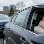 Woman experiencing neck pain after a rear-end car accident caused by whiplash